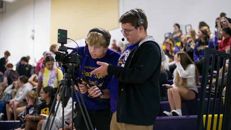 students filming basketball game for live broadcast